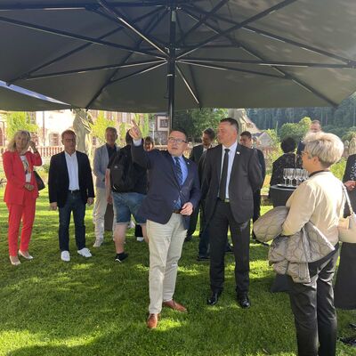Landrat Christoph Schauder (links) zeigt Landrat Udo Witschas (rechts) und der Delegation aus dem Partnerlandkreis Bautzen das Kloster Bronnbach. 